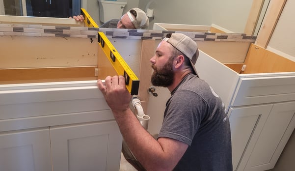 remodeling-specialist-making-sure-the-cabinets-are-2022-11-12-09-54-06-utc