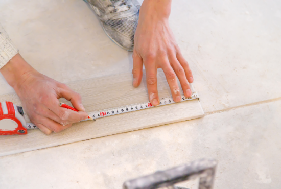 Person laying luxury vinyl tile